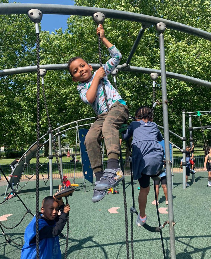 Children climbing and playing together in a public playground