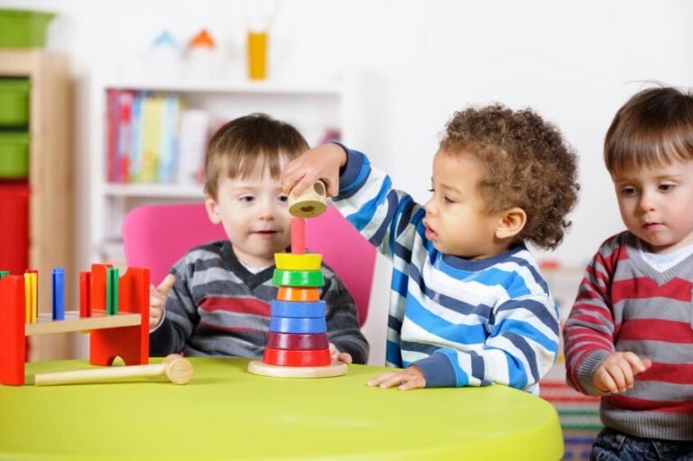 Young children concentrating on a colourful construction activity