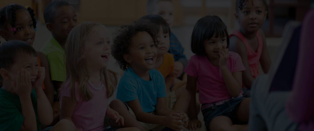A diverse group of young children listening together in a childcare setting
