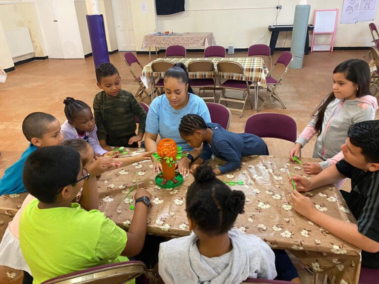 Children and adults working together on a creative table activity