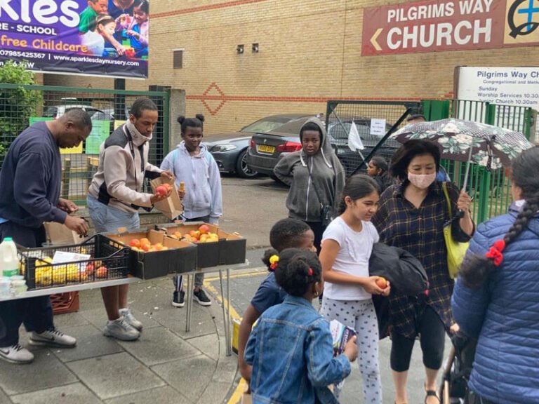 Activity leaders preparing food at an outdoor community event