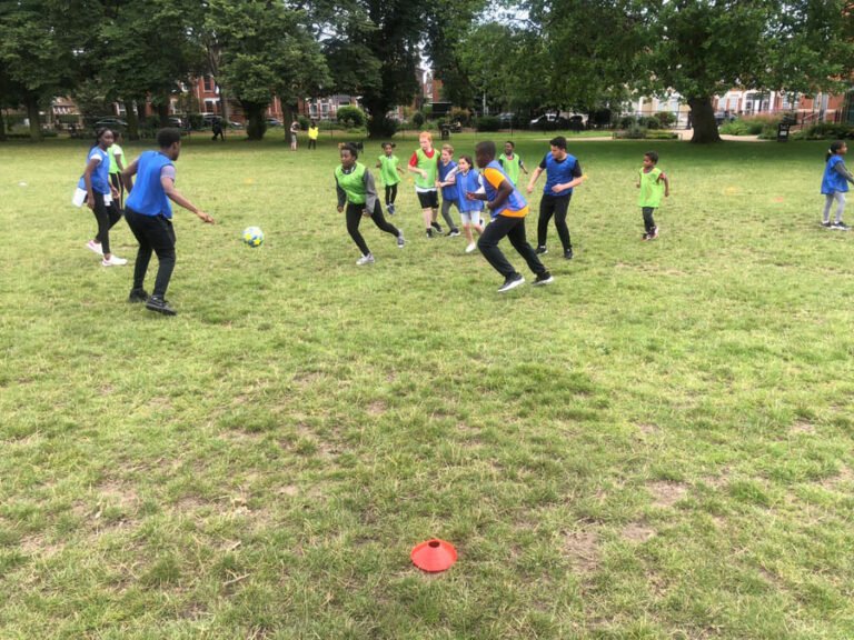 Children and leaders playing an energetic team game outdoors