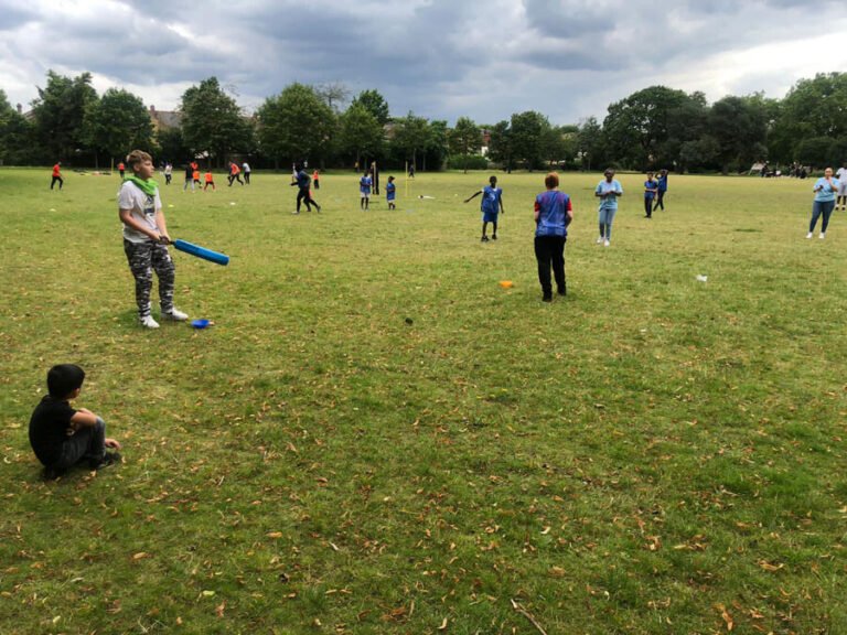 Children taking part in games across a large grass field