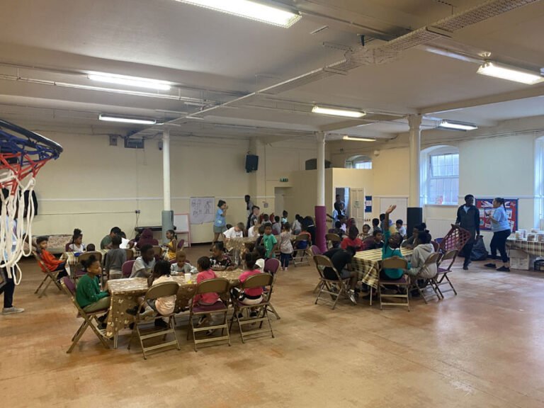 Children gathered for activities in a large community hall