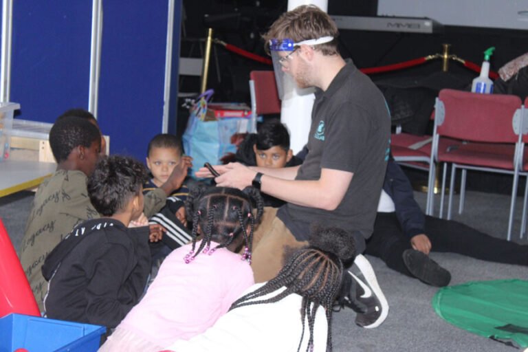 Children meeting an animal with support from an activity leader