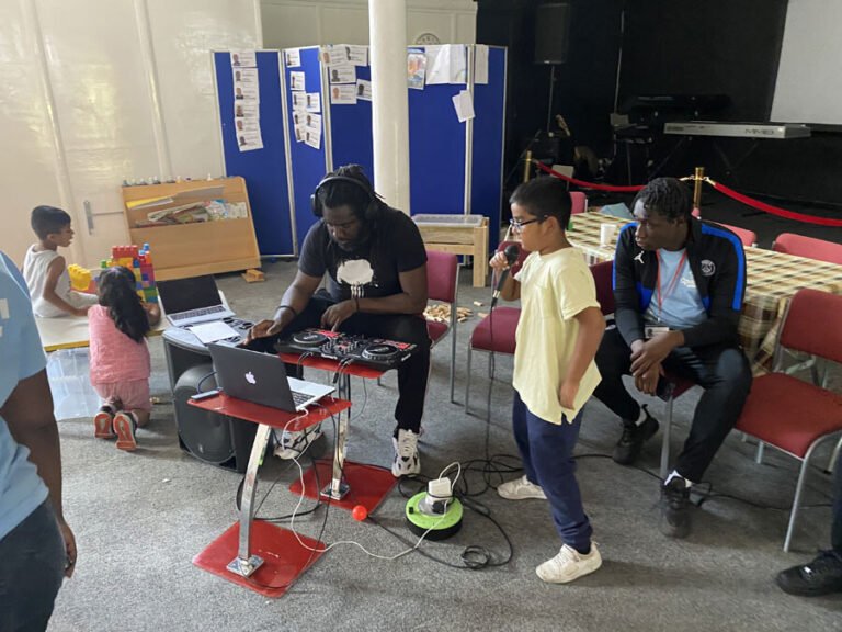 Children and leaders sharing a table-based play activity