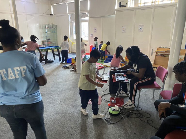 Children exploring creative and music activities in the hall