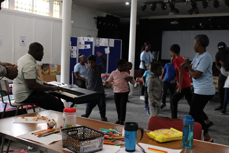 Children moving between creative activity stations