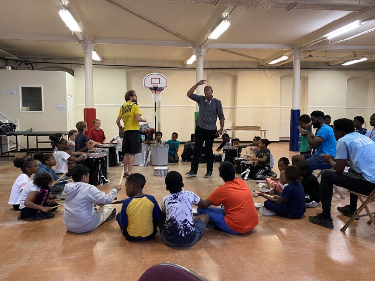 Children watching a group demonstration in the community hall
