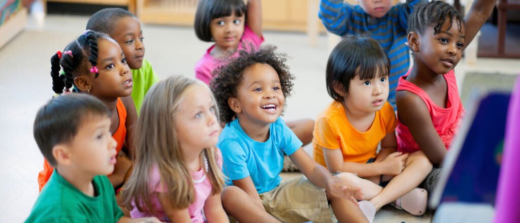 A group of young children enjoying a shared learning activity